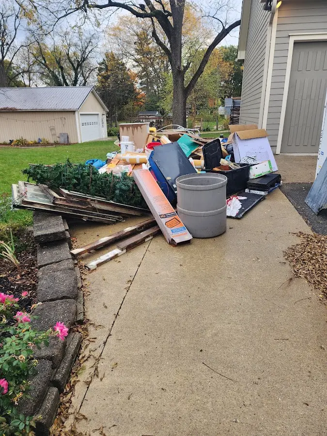 Dumpster being loaded with debris for Commercial Dumpster Rental in Algood